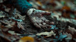 © Domingo - Close up of a dirty hand of a dead boy or girl half-buried, surrounded by dry leaves, found in a dark park or forest. Crime scene with a person murdered by a serial killer