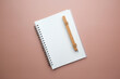 The mockup white notebook and wooden pen for dairy, journal, and planner concept.