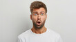 A man with a surprised expression on his face. He is wearing a white shirt. Concept of shock or disbelief