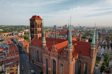 Wall Mural - St. Mary's Basilica Beautiful panoramic architecture of old town in Gdansk, Poland at sunrise. Aerial view drone pov. Small vintage historical buildings Europe Tourist Attractions travel destination