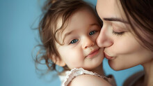 Mother Kissing Her Daughter Blue Isolated Background 