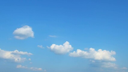 Wall Mural - Beautiful cumulus clouds slowly move across the sky. Calm landscape with white clouds. Lots of empty, blue sky.