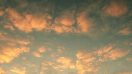 Wall Mural - Sky at sunset. Clouds illuminated by the yellow-orange sun. Calm romantic background on the theme of inspired dreams.