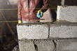 Worker builds a wall in the building site.