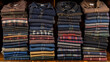 A stack of shirts with a variety of colors and patterns