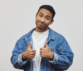 Poster - Happy, man and portrait with thumbs up, fashion and modern style in a studio with smile. Trendy, like and success emoji hand sign with confidence and casual clothes with jacket and grey background