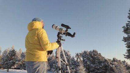 Wall Mural - amateur astronomer looking at the sun trough a telescope with special solar filter.