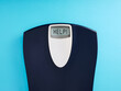 Digital bathroom scale with the word help on blue background.