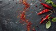 Artistic arrangement of chili pepper flakes and fresh chili pods on a slate surface, highlighting the contrast and details