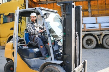 Man worker at forklift driver happy working in industry factory logistic ship