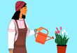 © Westend61 - Woman in beanie watering tulips against blue background