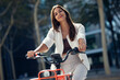 © Westend61 - Smiling businesswoman riding bicycle on sunny day
