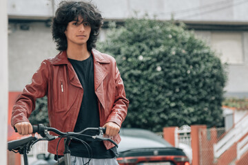 Wall Mural - urban young man with bike on the street