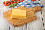Fototapeta Kuchnia - Piece of natural organic cheese over board