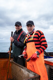 Fototapeta Konie - Portrait of two fisherman on a lobster fishing boat