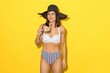 Stunning photos of a young woman in a swimsuit and sun hat, evoking the warm glow of summer holidays