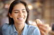 Happy woman with white smile looking at croissant