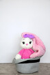 Bunny sits in a hat. Long ears. Hobby crochet. Handmade. Amigurumi. Pink knitted rabbit. Soft toy. Crocheting of soft toys
