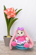 Hobby crochet. Handmade. Amigurumi. Pink knitted rabbit. Soft toy. Long ears. Crocheting of soft toys. Bunny and flower