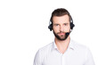 Portrait with copy space, empty place for advertisement of  harsh virile operator having headset with microphone on head looking at camera isolated on grey background
