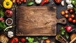 Top view of a wooden cutting board surrounded by fresh vegetables and herbs