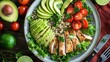 Healthy salad bowl with quinoa, tomatoes, chicken, avocado, lime and mixed greens (lettuce, parsley) on wooden background top view. Food and health. copy space for text.