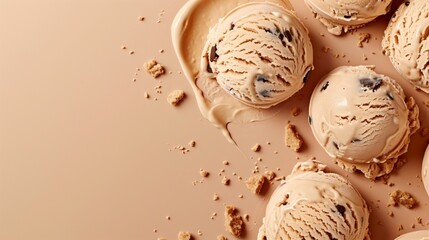 Wall Mural - Scoops of melting cookie dough ice cream with crumbs on a beige surface.