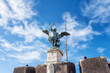 Detailed close up view of Saint Michael archangel statue with wings and sword at top of Saint Angelo castle, Rome, Italy. .
