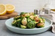Delicious roasted Brussels sprouts on grey table, closeup