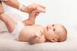 Physiotherapist performing infant development exercise