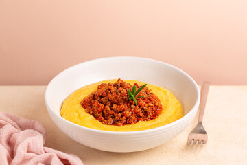 Wall Mural - Polenta with ragu or meat and tomato sauce bolognese. Boiled cornmeal porridge.