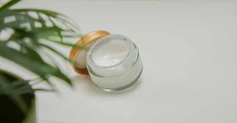 Skincare jar with cosmetic anti aging cream on white background