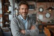 © Larisa AI - Confident and relaxed businessman leaning with crossed arms in a well-lit modern cafe with an approachable smile