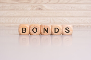 Wall Mural - wooden cubes with letters form the expression BONDS. finance and business concept