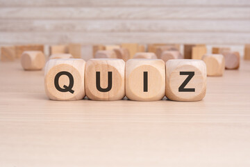 Sticker - the word QUIZ is elegantly displayed on a beige hardwood rectangle block