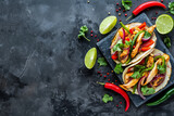 Fototapeta Tęcza - Vibrant Mexican tacos with fresh ingredients on a dark concrete background in a top view style