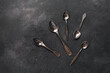 Vintage spoons on a dark grunge background. Top view, flat lay.