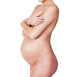 Naked pregnant woman posing against white background, isolated