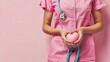 Woman in Pink Scrub Suit Holding Pink Heart