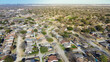 Aerial view suburban residential houses with downtown Dallas in distant background, Master Planned Communities DFW subdivision design with cul-de-sac dead-end residential street shapes keyholes