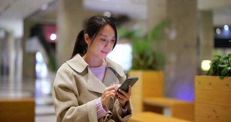 Poster - Woman use mobile phone in shopping center