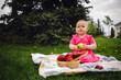 © Anton Dios - Young Girl in a Pink Dress Enjoying an Apple on a cloudy Day at the Park