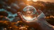 Marvel at the sheer beauty of a transparent glass globe cradled delicately in a hand, its flawless surface reflecting the surrounding world with breathtaking clarity