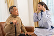 Portrait of smiling caring asian doctor service help support discussing and consulting taking care, caring, caregiver with senior elderly asian man at home visit.senior retirement home care