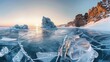 The stunning winter landscape of frozen Lake Baikal at sunrise features snowy ice hummocks with clear blue ice formations