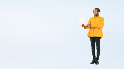 Full body photo of a black man looking at laptop. (We also sell PNGs that are cropped and have transparent background. Please search for 