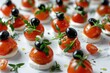 © Ева Поликарпова - Fresh mini tomatoes and black olives on a white plate, perfect for food blogs or restaurant menus