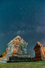 Wall Mural - Sleman, Indonesia - July 14,  2015. Milky Way galaxy stretches in the sky Sleman with the foreground of the ijo temple