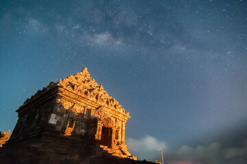 Wall Mural - Sleman, Indonesia - July 14,  2015. Milky Way galaxy stretches in the sky Sleman with the foreground of the ijo temple