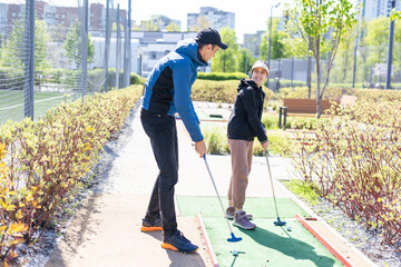 Wall Mural - cute little girl on a miniature golf course.